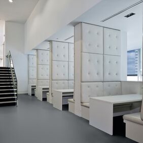 Seating area with private booths and dark grey flooring