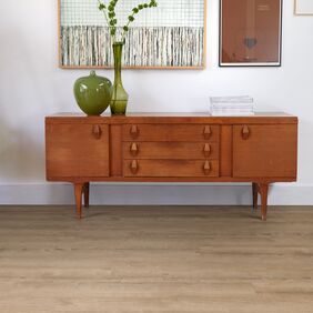 Console table, vase, pictures, wood floor