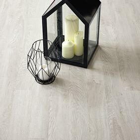 Close up of Bianco Oak ligh wood effect flooring with glass lantern and candle