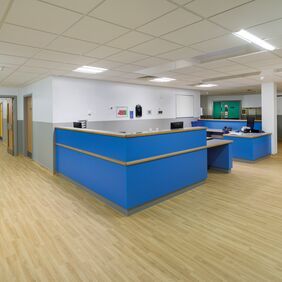 Light oak wood effect flooring in a hospital reception area 