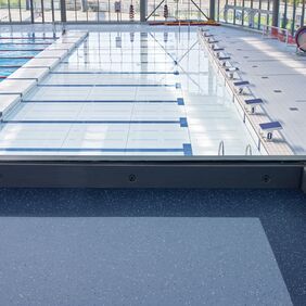 Dark blue safety flooring in a Public swimming baths spectator area