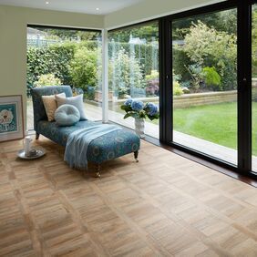 Chai Lounge with biofolds to garden area featuring light brown wood effect flooring laid in a Parquet Tramline design in Cambridge Parquet 