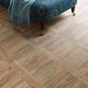 Close up of Chai Lounge featuring light brown wood effect flooring laid in Parquet Tramline design Cambridge Parquet