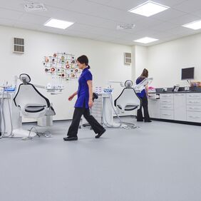 Light blue safety flooring in a Dentist room with chairs and dental nurses