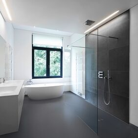 Dark coloured safety flooring in a large modern bathroom