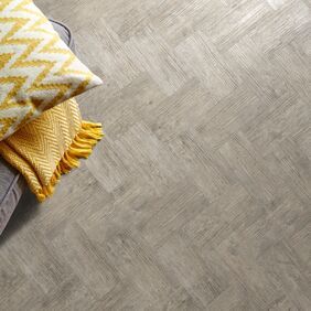 Close up of throw and cushions on a wood effect smoke brushed elm colour flooring