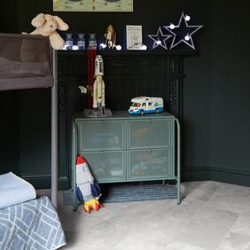 Grey coloured slate effect flooring in a childs bedroom with black walls
