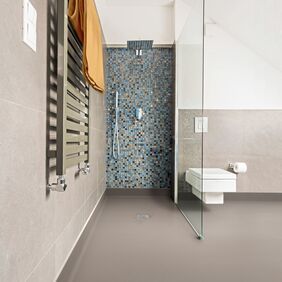 Neutral coloured flooring in a wet room shower area 
