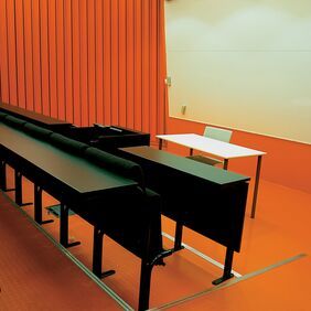 Lecture hall with orange flooring and walls