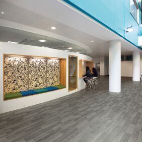 Silver oak wood effect flooring in a highschool breakout area