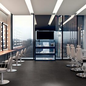 Dark flooring laid a in beauty room with working stations