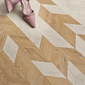 Close up of Miniature chevron White Metalstone tiles, alongside Sienna Oak. 