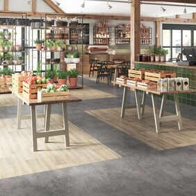 Grey stone and light wood effect flooring with zonal areas in a Garden centre indoor fruit and veg store