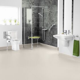 Neutral coloured flooring in a large adapted wetroom 