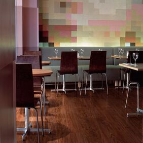 Dark walnut effect flooring in a restaurant dining area