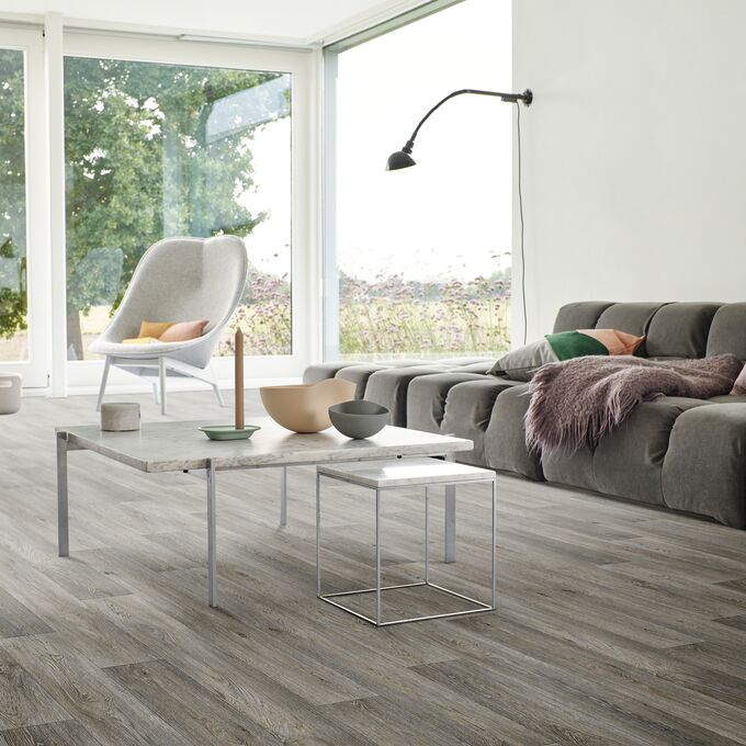 Living room, coffee table, chair, large windows, family room, grey wood flooring 