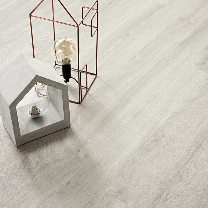 Close up of light wood effect flooring Bianco Oak with lantaren ornaments 