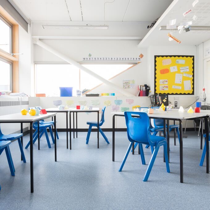 Light blue flooring in a classroom with table and chairs