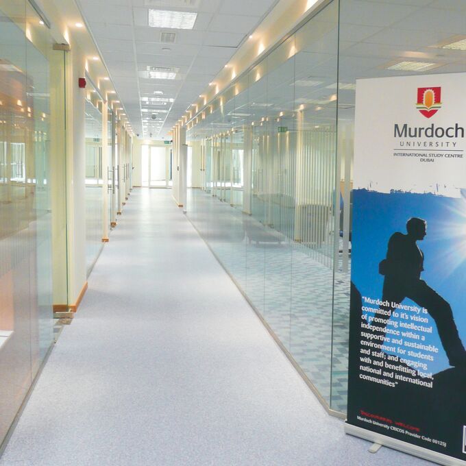 Light blue flooring in a long university corridor