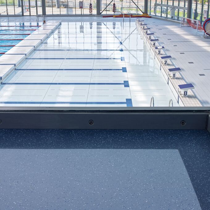 Dark blue safety flooring in a Public swimming baths spectator area