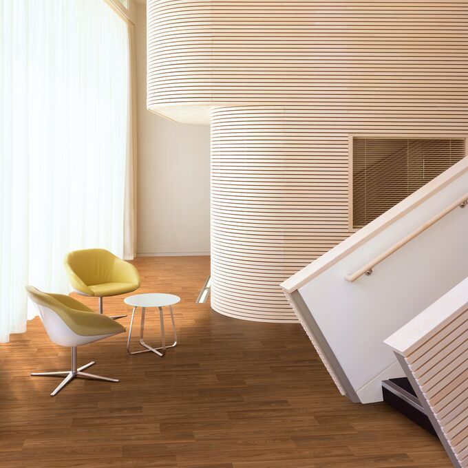 Walnut effect flooring laid in a minimalist waiting area