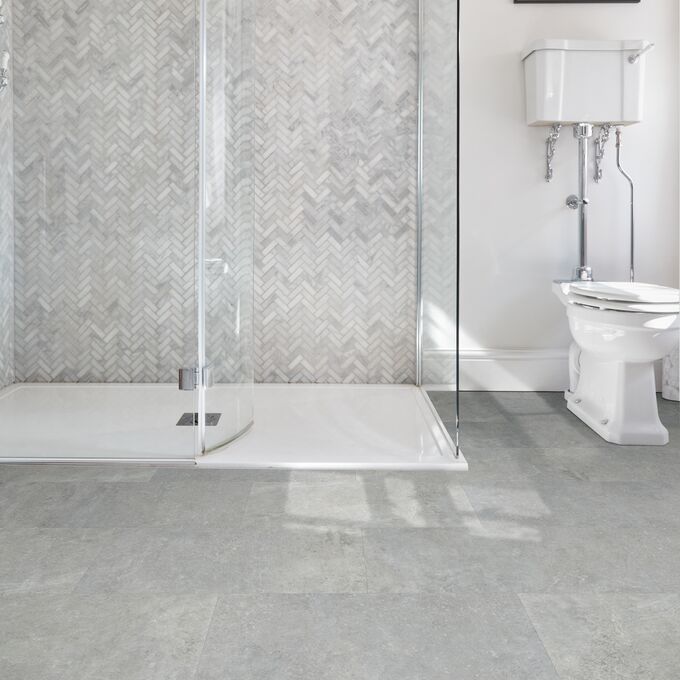 Bathroom, Walk in glass shower, grey tiles, toilet, grey cement style flooring tiles