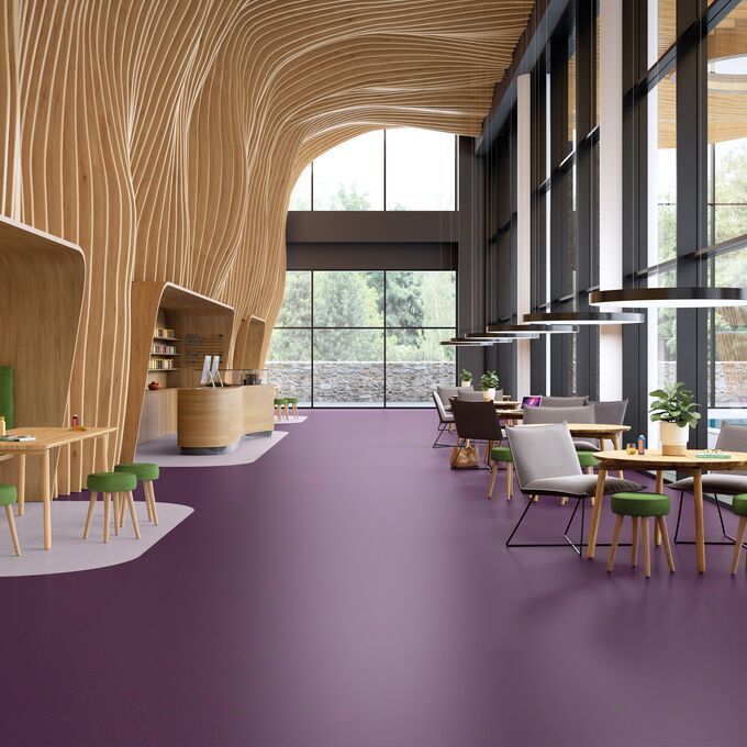 Waiting area with a deep purple coloured flooring and table and chairs