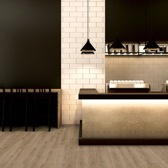 Light coloured oak effect flooring laid on a restaurant eating area 