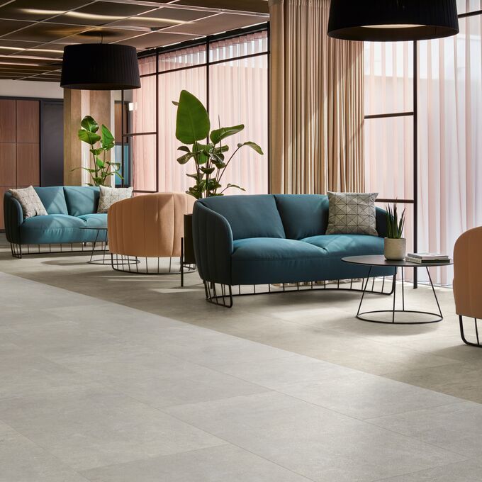 Grey cement effect flooring in a commercial waiting area 