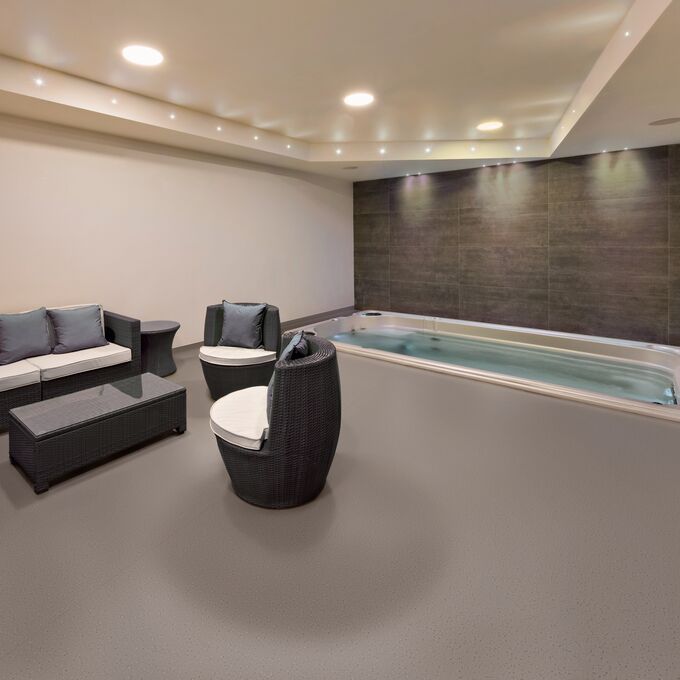 Brown colour safety flooring in a spa relaxation area with seating and hot tub