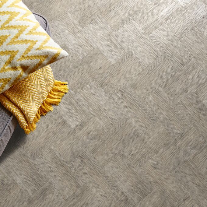 Close up of throw and cushions on a wood effect smoke brushed elm colour flooring