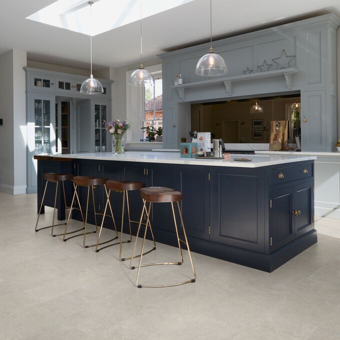 Kitchen island, stools, ceiling lights, flowers, vase, cement tile flooring 