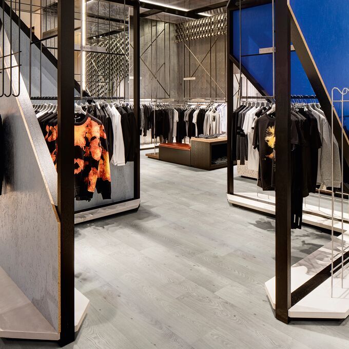 Grey coloured oak effect flooring laid in a clothing store