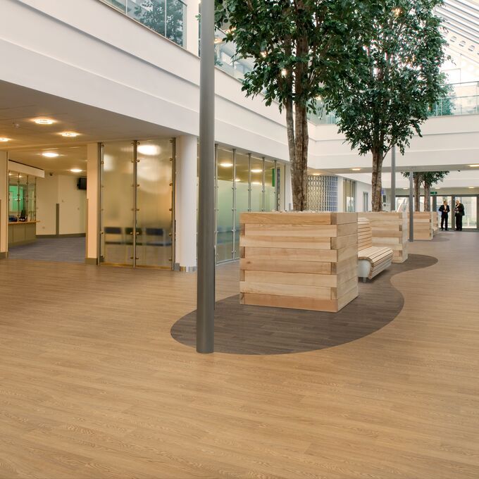 Light coloured oak effect flooring in a commercial building corridor