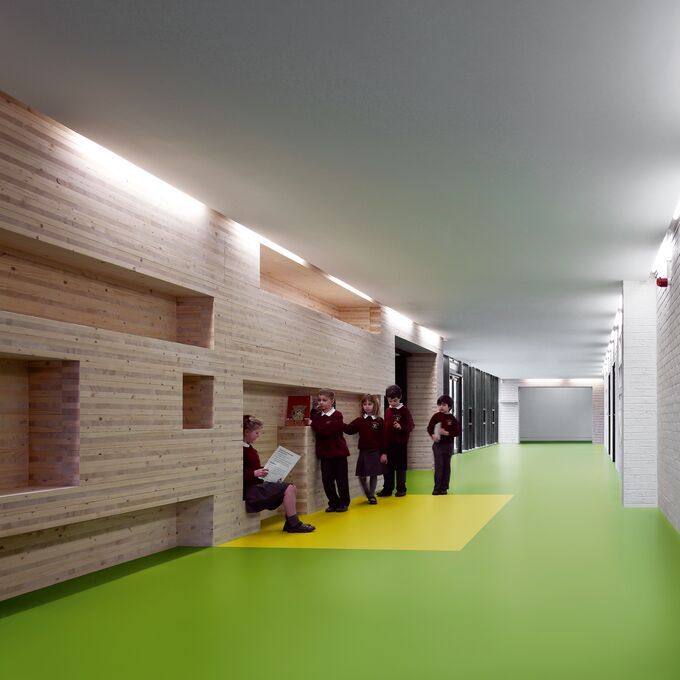 School corridor with pupils standing and green flooring