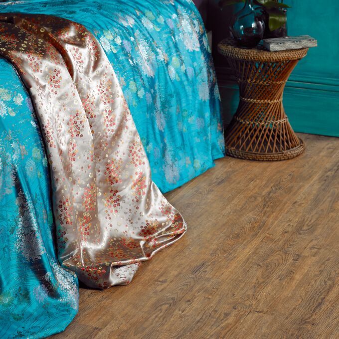 Close up of dark wood effect flooring random laid planks in Wild Amber Oak 