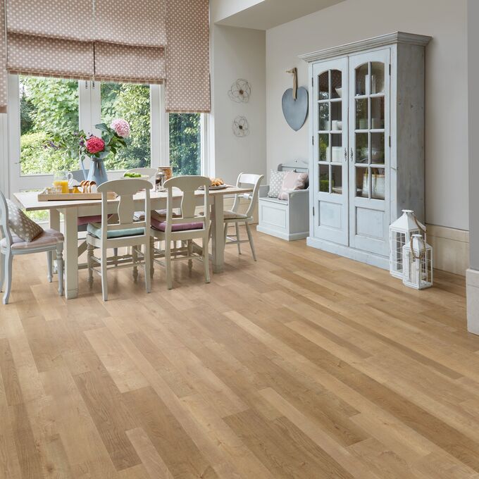 Modern family dining area with white wood table and chairs feturing a natural timber wood effect flooring in Salvaged Timber 
