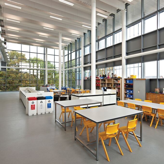 Large academic area with table and chairs and grey coloured flooring