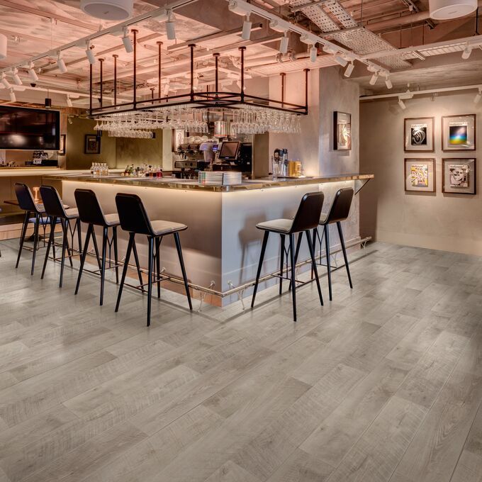 Grey oak effect flooring in a bar area